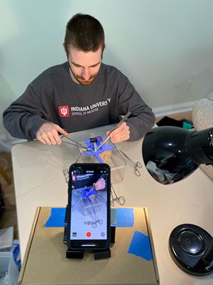 IU School of Medicine Student Joshua Matthews records demonstration of appendectomy surgery while recording on an iphone.