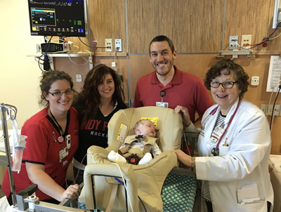 Marilyn Bull and the Riley team with an infant patient in car seat