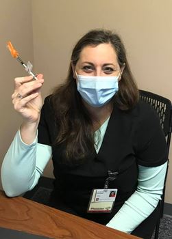 Katherine Hiller with a vaccine syringe in 2020