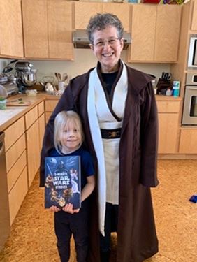 Gutmann in Jedi robe with child