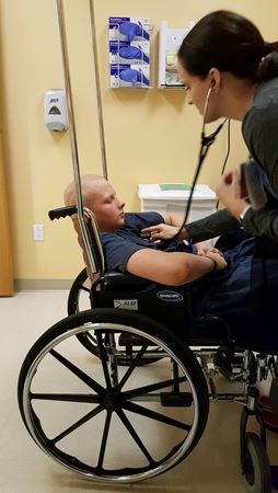 Devin in hospital wheelchair