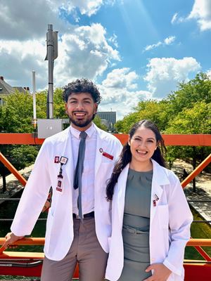 Hugo and Alejandra Rodriguez in white coats by Indy canal