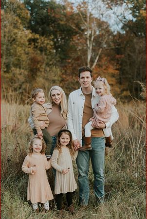 Family portrait of Chelsea and Cameron Fathauer with their four children in the fall