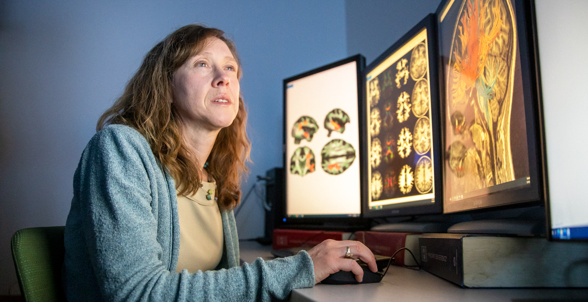 kellie mcdonald works at a monitor reviewing brain imaging
