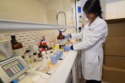Image of lab member working with chemicals
