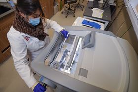 Lab member working with lab equipment