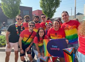 a group of people at the indy pride parade wearing rainbow tie dye shirts