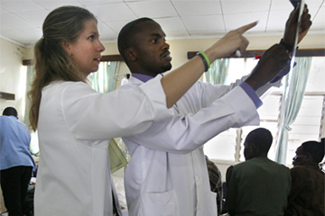 two residents examine a chart together during the kenya elective