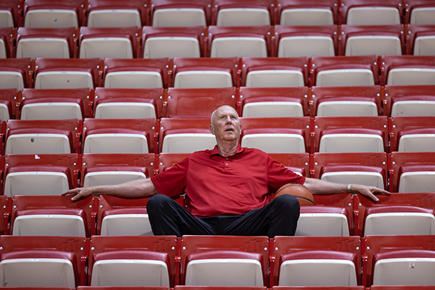 Ted Kitchel sitting in seats at a basketball stadium
